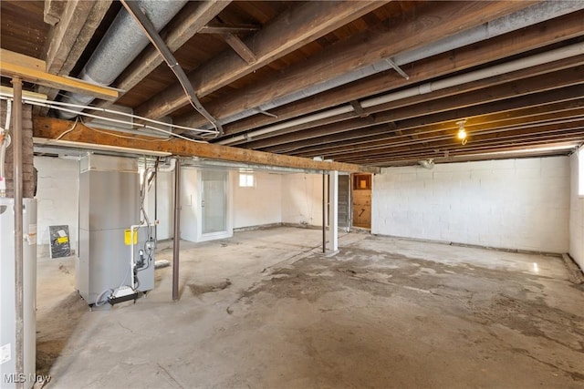 basement featuring gas water heater and heating unit