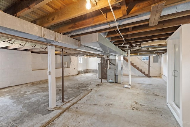 basement featuring heating unit and water heater