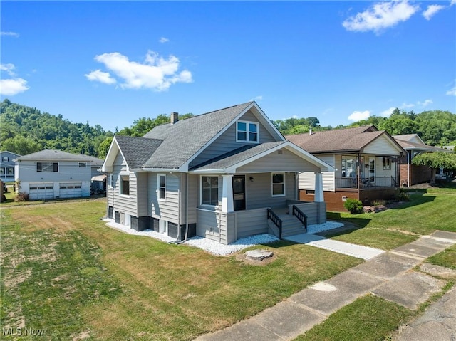 view of front of property with a front yard and covered porch