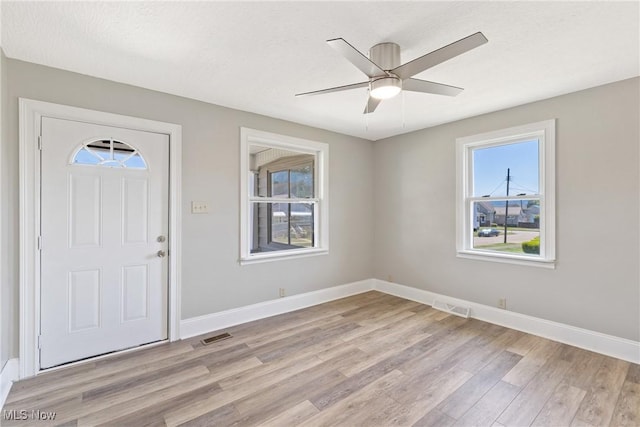 foyer with ceiling fan and light hardwood / wood-style floors