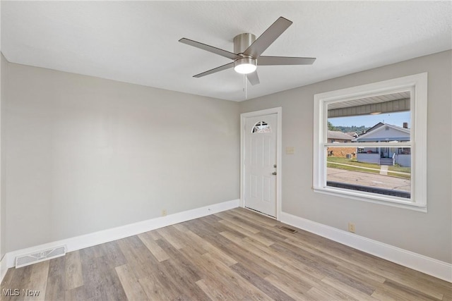 spare room with ceiling fan and light hardwood / wood-style floors