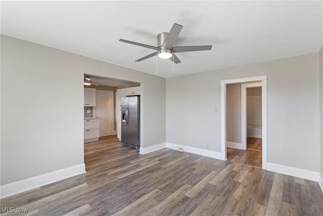 empty room featuring ceiling fan and dark hardwood / wood-style floors