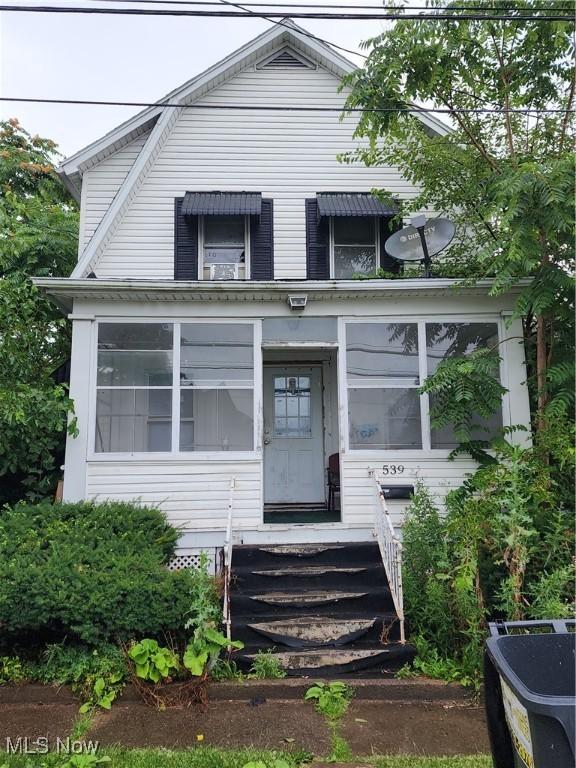 view of front of home with a sunroom