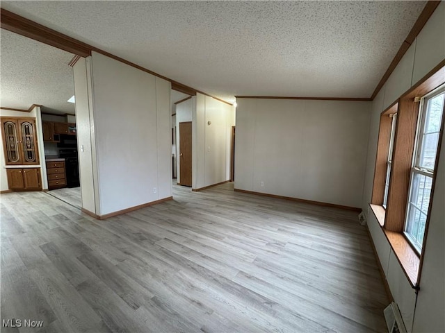 unfurnished living room with light wood-type flooring, a textured ceiling, and crown molding