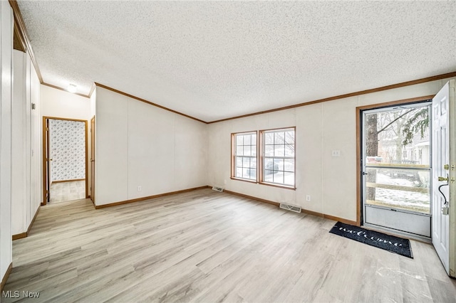 entryway featuring crown molding, light hardwood / wood-style floors, and a textured ceiling