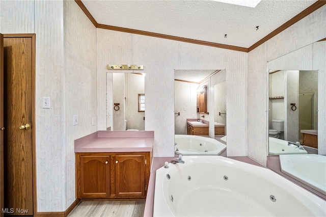 bathroom with crown molding, a bathtub, vanity, a textured ceiling, and toilet