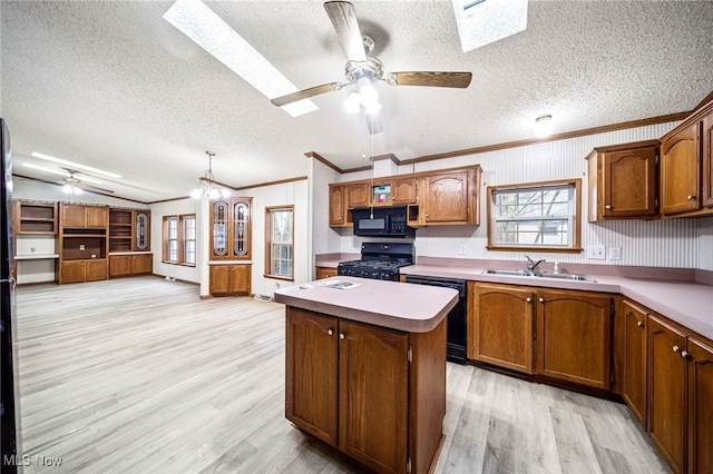 kitchen featuring sink, light wood-type flooring, black appliances, and a kitchen island