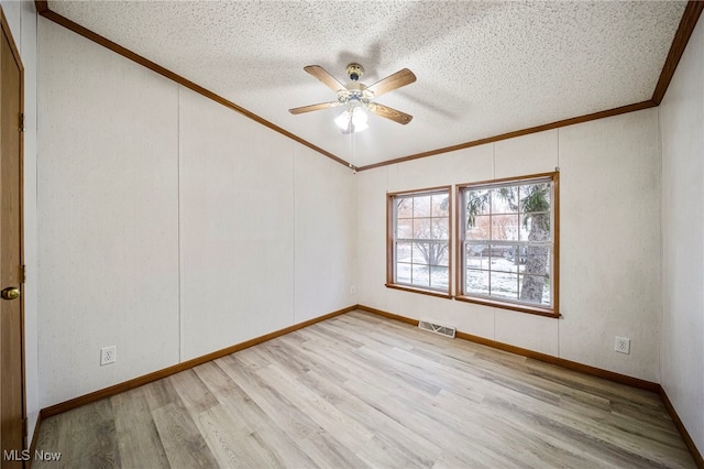 spare room featuring ceiling fan, crown molding, light hardwood / wood-style flooring, and a textured ceiling