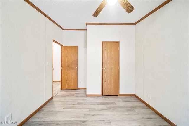 spare room with crown molding, ceiling fan, light hardwood / wood-style floors, and a textured ceiling