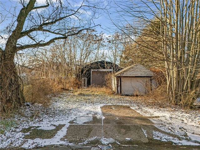 snowy yard featuring a garage