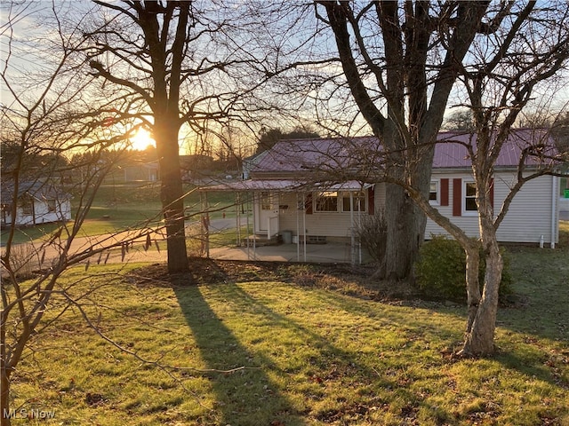 yard at dusk with a patio