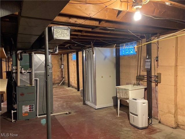 basement with sink and heating unit