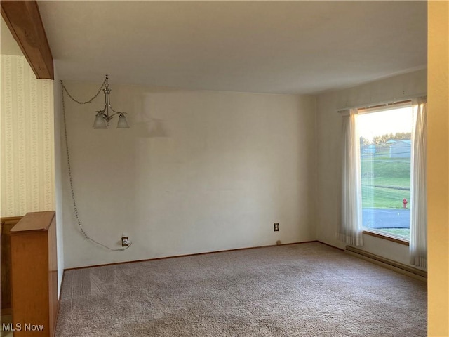 carpeted spare room with beamed ceiling