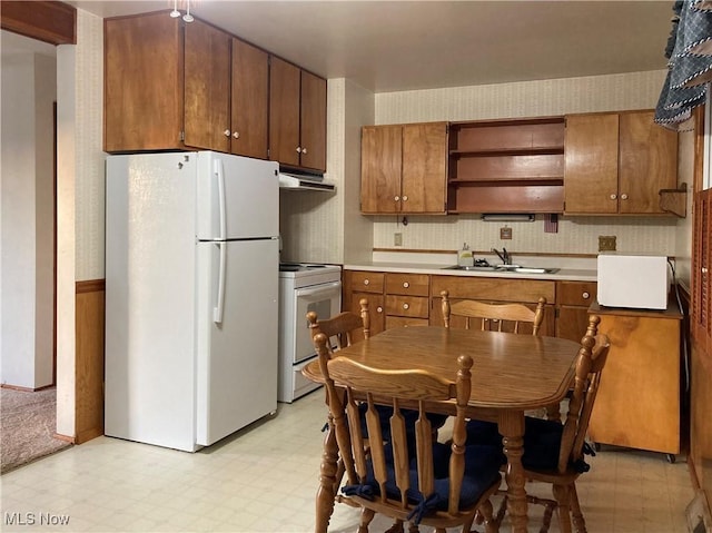 kitchen featuring white appliances and sink