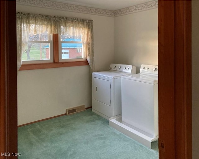 laundry room featuring carpet flooring and washer and dryer