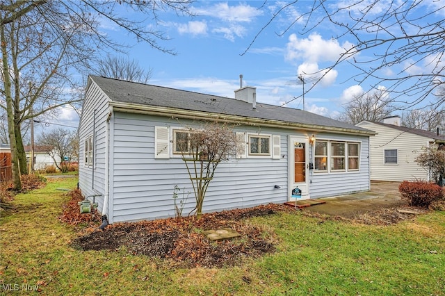 back of property featuring a yard and a patio area