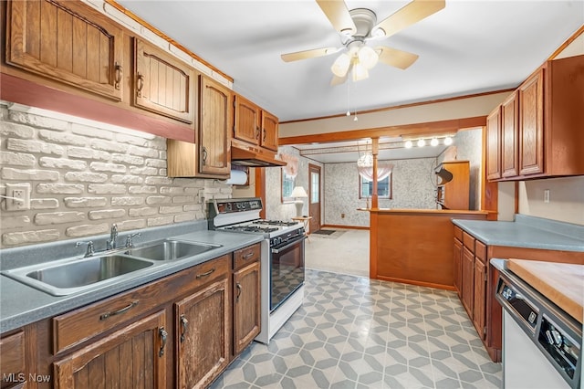 kitchen featuring white gas stove, ceiling fan, sink, and dishwashing machine