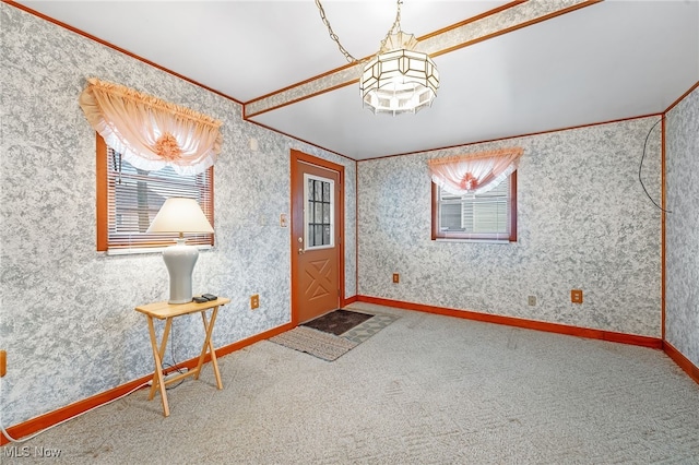 entryway featuring carpet flooring, ornamental molding, and a wealth of natural light