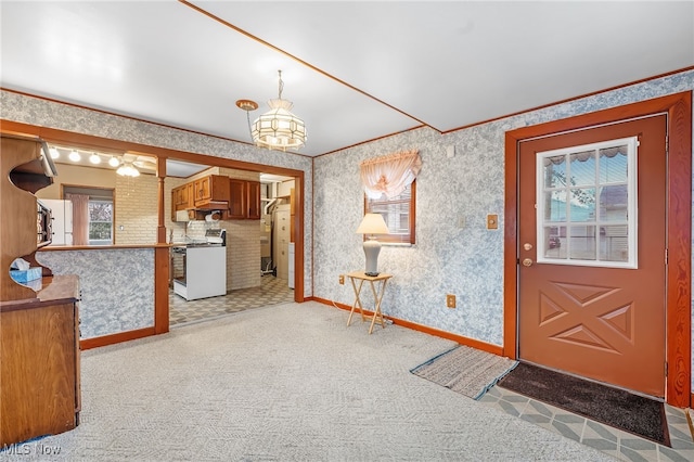 foyer entrance featuring light colored carpet and an inviting chandelier