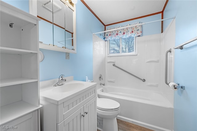 full bathroom with tub / shower combination, hardwood / wood-style floors, toilet, vanity, and ornamental molding