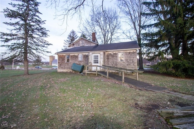 rear view of property with a lawn