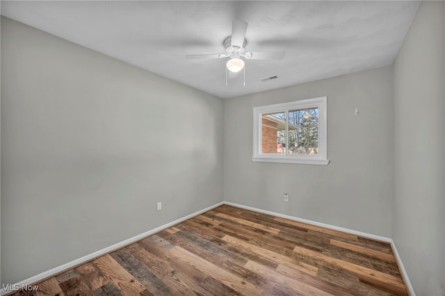 spare room with ceiling fan and hardwood / wood-style flooring