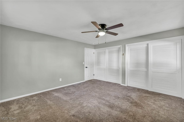 unfurnished bedroom with ceiling fan, carpet floors, and multiple closets