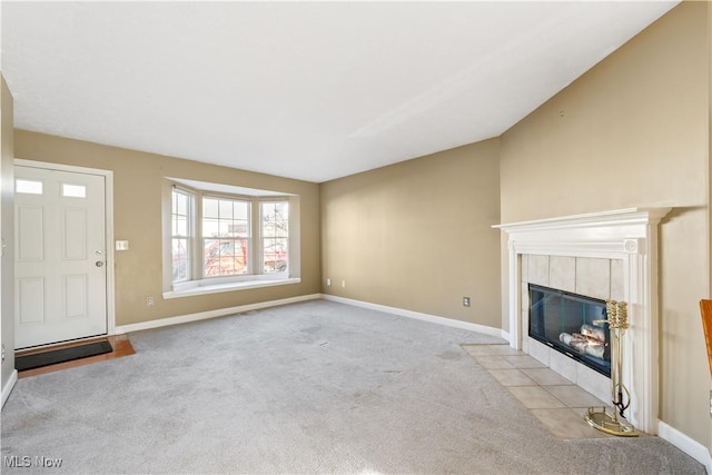 unfurnished living room with a fireplace, light colored carpet, and vaulted ceiling