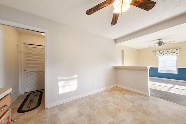 spare room with a textured ceiling and ceiling fan