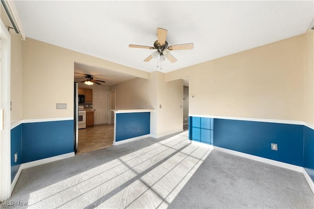 empty room with light carpet and ceiling fan