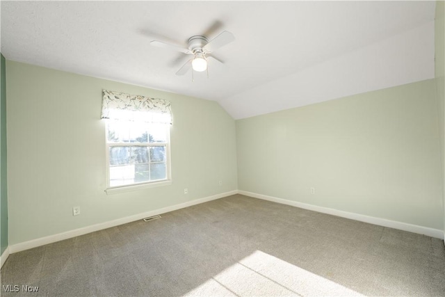 bonus room with carpet floors, vaulted ceiling, and ceiling fan