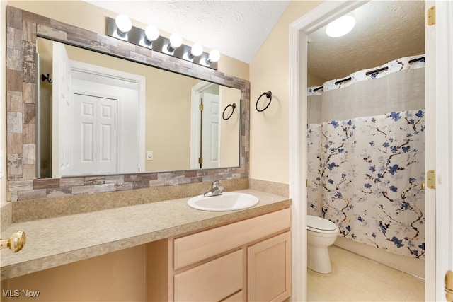 full bathroom featuring shower / bath combination with curtain, tile patterned floors, vanity, a textured ceiling, and toilet