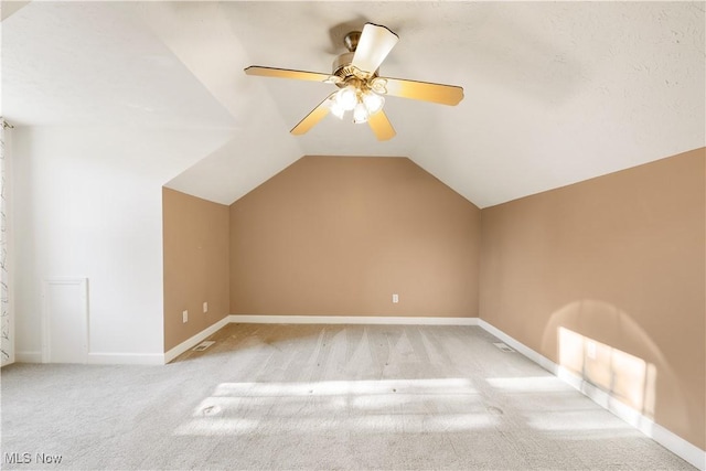 bonus room featuring light carpet, vaulted ceiling, and ceiling fan