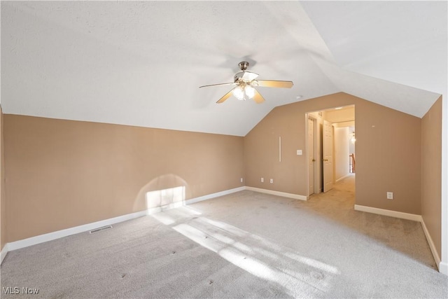 additional living space with light carpet, ceiling fan, and lofted ceiling