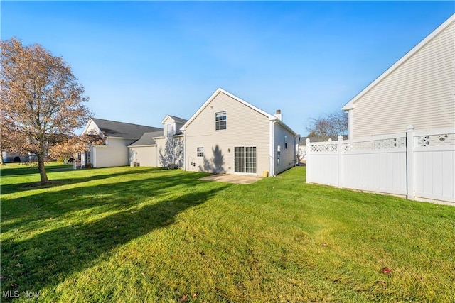 back of property featuring a lawn