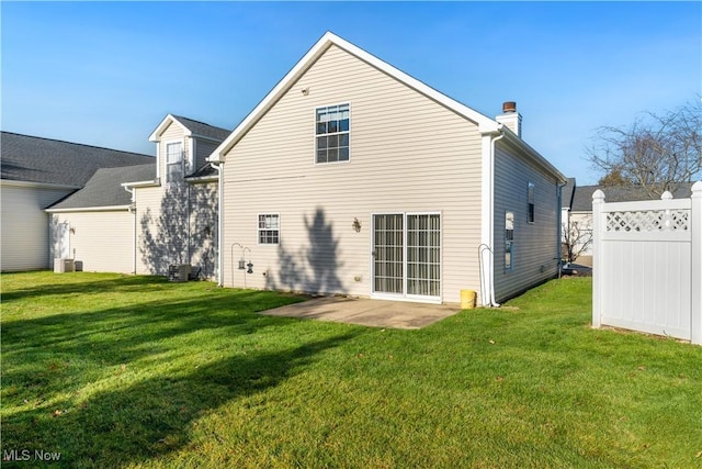 back of house with cooling unit, a patio area, and a yard