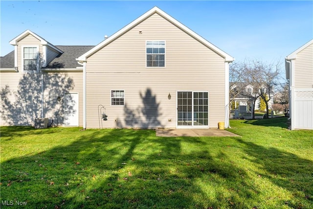 rear view of property with a lawn and a patio area