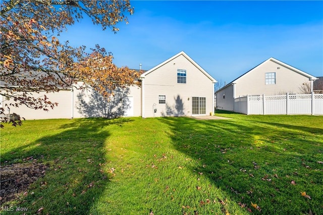 back of house featuring a yard