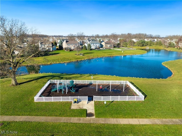 exterior space with a playground and a water view