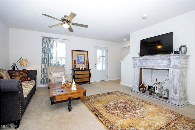 carpeted living room featuring ceiling fan