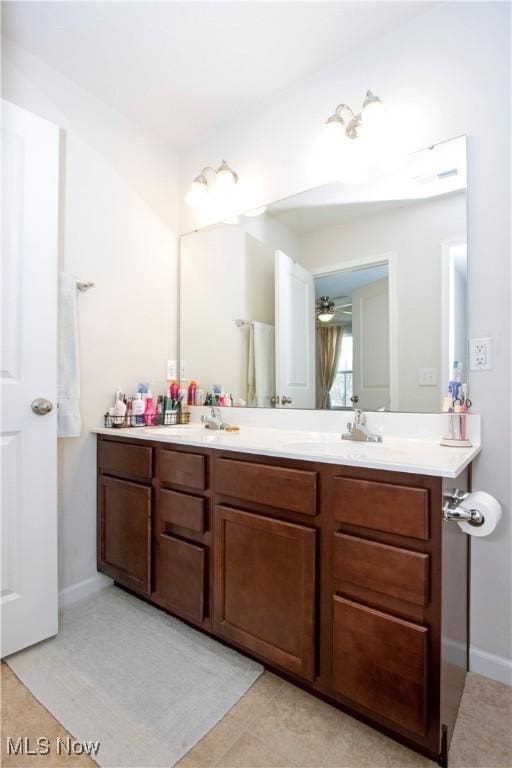 bathroom with tile patterned floors, vanity, and ceiling fan