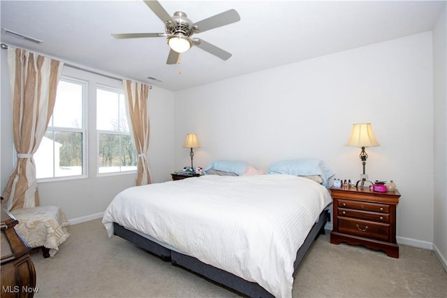 bedroom with ceiling fan and light carpet