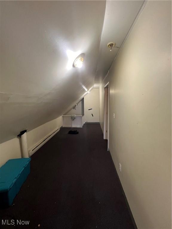 bonus room with baseboard heating and lofted ceiling