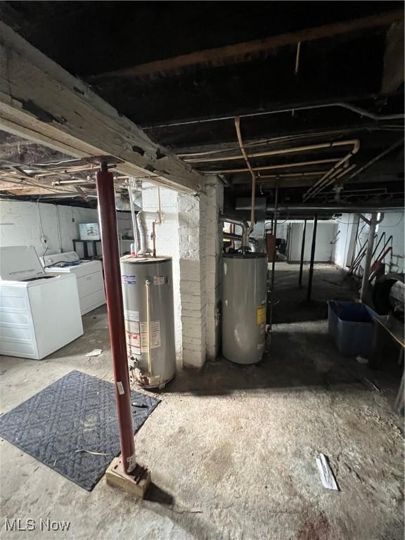 basement with washer and clothes dryer and water heater