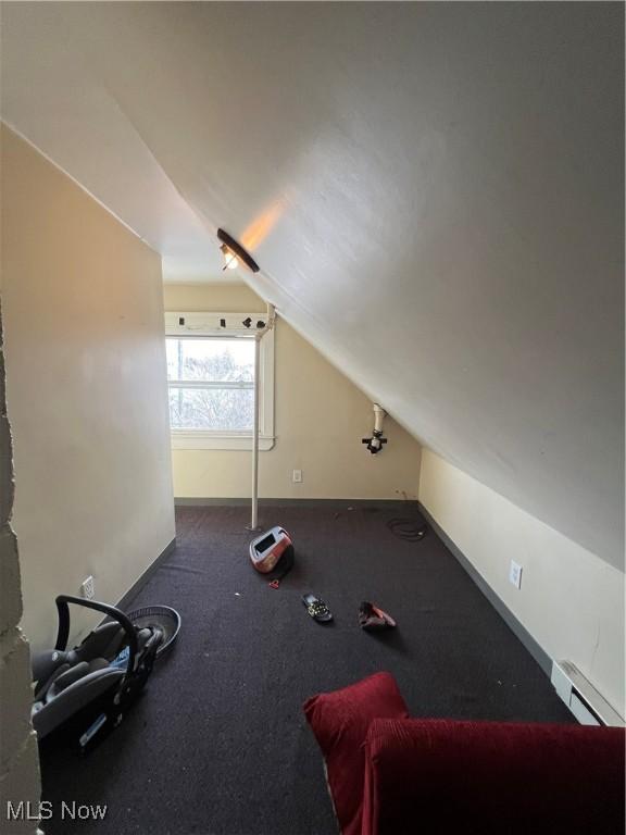 bonus room featuring vaulted ceiling and a baseboard radiator