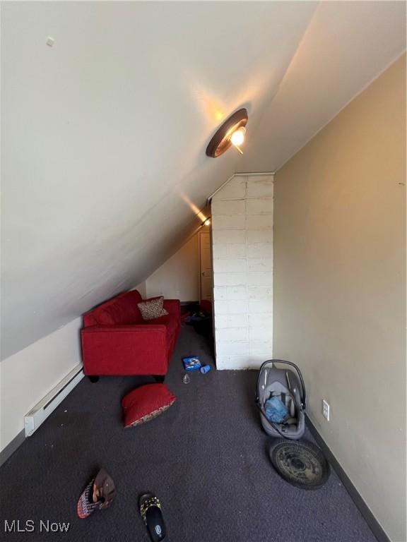 bonus room with lofted ceiling and a baseboard radiator