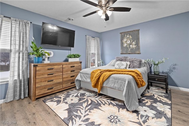 bedroom with ceiling fan and light wood-type flooring