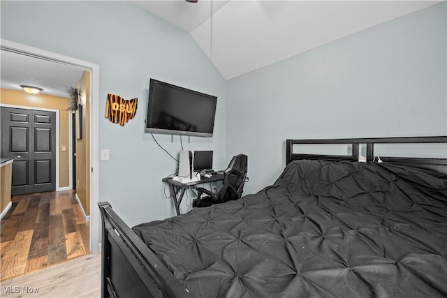 bedroom with wood-type flooring and lofted ceiling