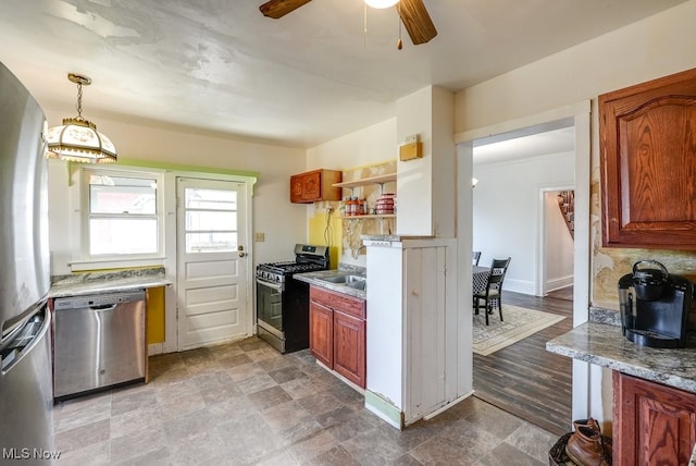 kitchen featuring hardwood / wood-style floors, sink, hanging light fixtures, ceiling fan, and appliances with stainless steel finishes