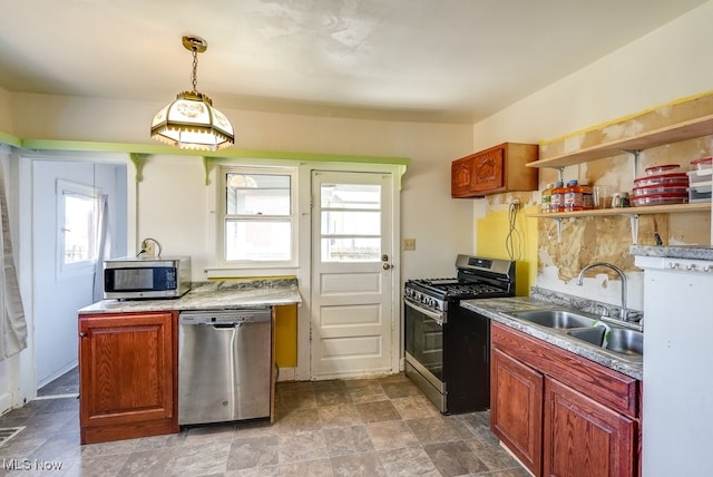 kitchen with sink, a healthy amount of sunlight, decorative light fixtures, and appliances with stainless steel finishes